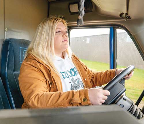 Female truck driver in truck cab