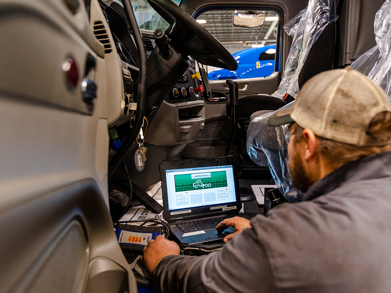 Truck technician working on engine